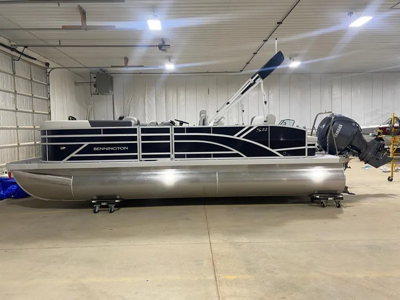Slide: The Image of 2025 Bennington 22SSB-SPS pontoon boat in a spacious indoor garage. - 7