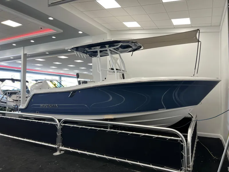 Slide: The Image of 2025 Blackfin 222CC boat displayed in a showroom with modern lighting. - 0