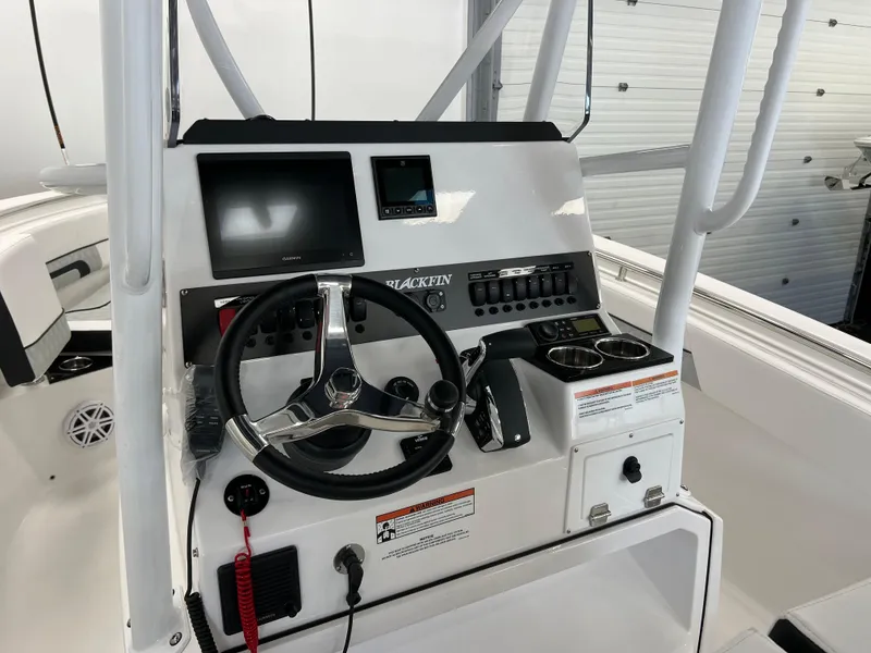 Slide: The Image of 2025 Blackfin 222CC boat console with steering wheel, controls, and display screens. - 10