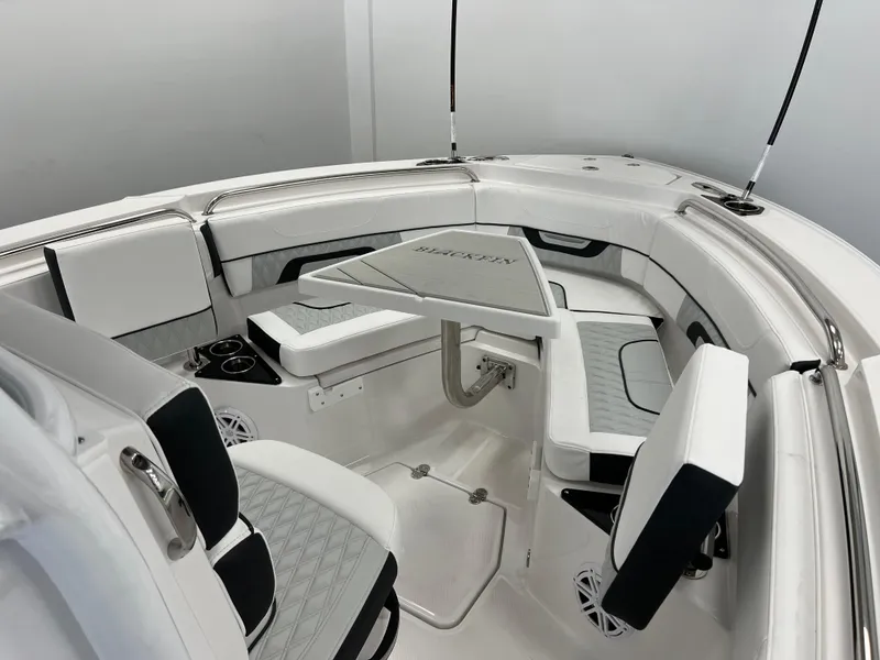 Slide: The Image of 2025 Blackfin 222CC boat interior with seating and table, featuring modern design and amenities. - 12