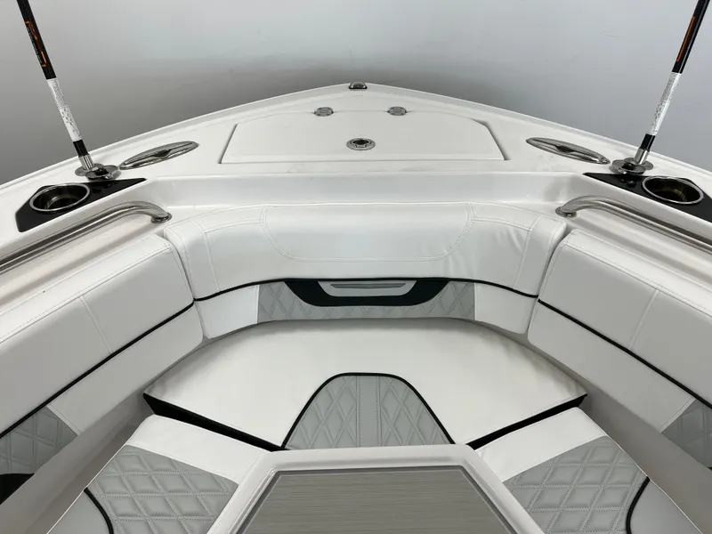 Slide: The Image of 2025 Blackfin 222CC boat interior with white cushioned seating and rod holders. - 14