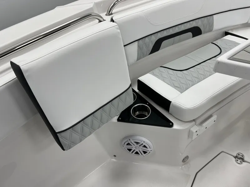 Slide: The Image of 2025 Blackfin 222CC boat interior with white and gray seating, cup holder, and speaker. - 15