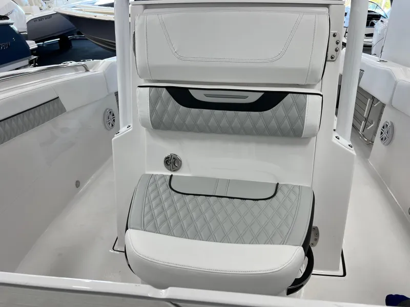 Slide: The Image of 2025 Blackfin 222CC boat interior with cushioned seating and modern design. - 17