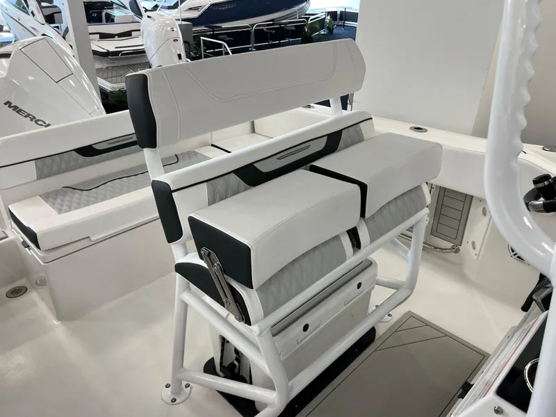 Slide: The Image of 2025 Blackfin 222CC boat interior with white cushioned seating and sleek design. - 21
