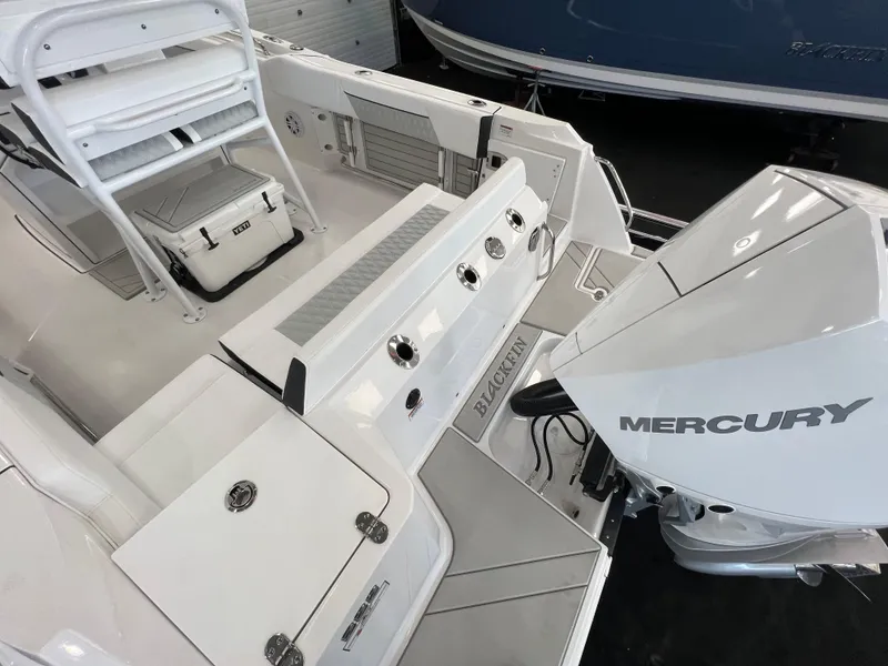 Slide: The Image of 2025 Blackfin 222CC boat with Mercury engine, white interior, and seating area. - 25