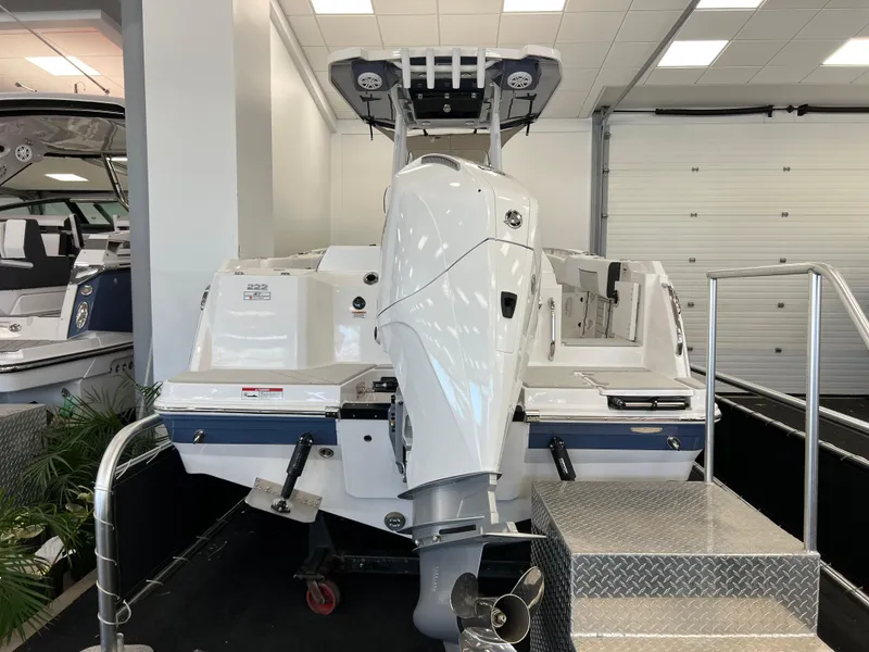 Slide: The Image of 2025 Blackfin 222CC boat with powerful outboard motor in showroom display. - 3