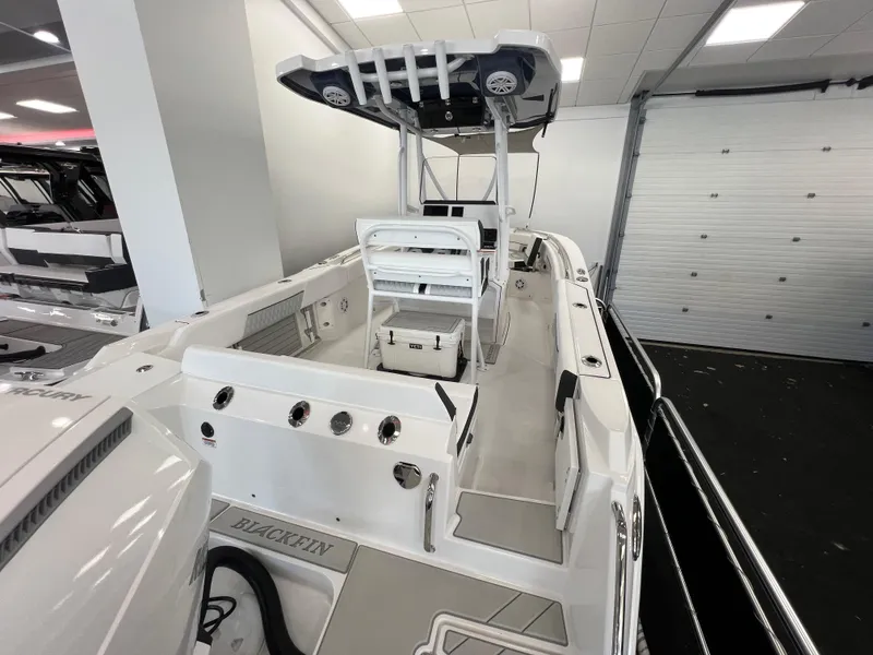 Slide: The Image of 2025 Blackfin 222CC boat interior with modern design and spacious layout in showroom. - 6