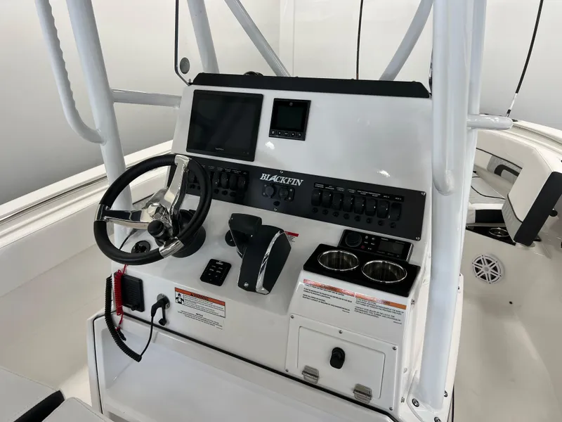 Slide: The Image of 2025 Blackfin 222CC boat console with steering wheel, controls, and display screens. - 8