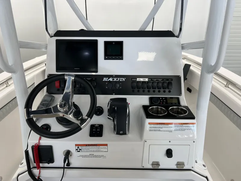 Slide: The Image of 2025 Blackfin 222CC boat console with steering wheel, controls, and display screens. - 9
