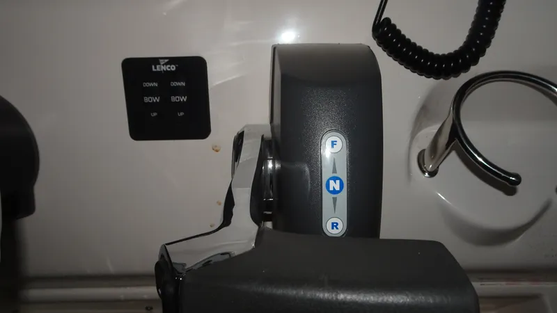 Slide: The Image of Close-up of 2015 Key West 219 FS boat controls and Lenco trim tab switch. - 16