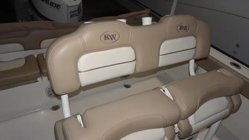 Slide: The Image of 2015 Key West 219 FS boat interior with tan and white cushioned seating. - 17