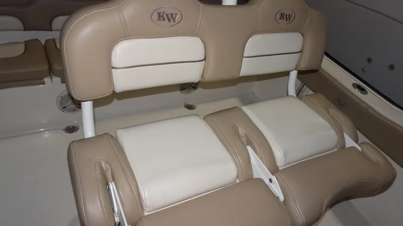 Slide: The Image of 2015 Key West 219 FS boat interior with beige and white cushioned seating. - 18