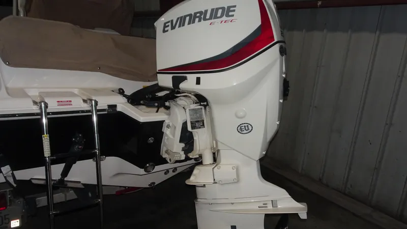 Slide: The Image of 2015 Key West 219 FS boat with Evinrude E-TEC outboard motor in a garage. - 2
