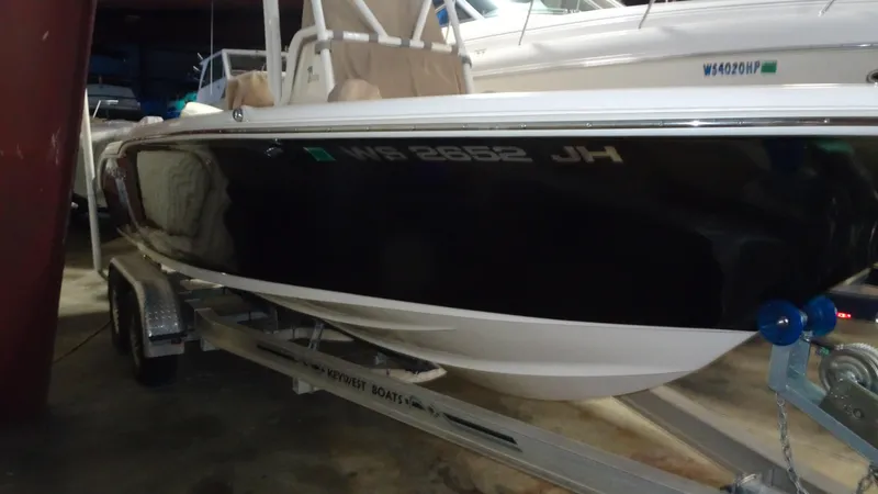 Slide: The Image of 2015 Key West 219 FS boat on trailer in storage facility. - 24