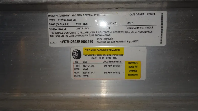 Slide: The Image of Label on a 2015 Key West 219 FS trailer with tire and loading information. - 26
