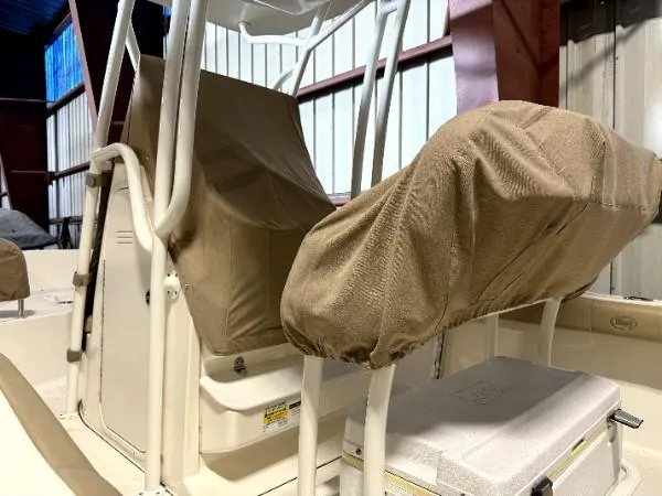 Slide: The Image of 2015 Key West 219 FS boat seats with protective covers in a storage facility. - 4