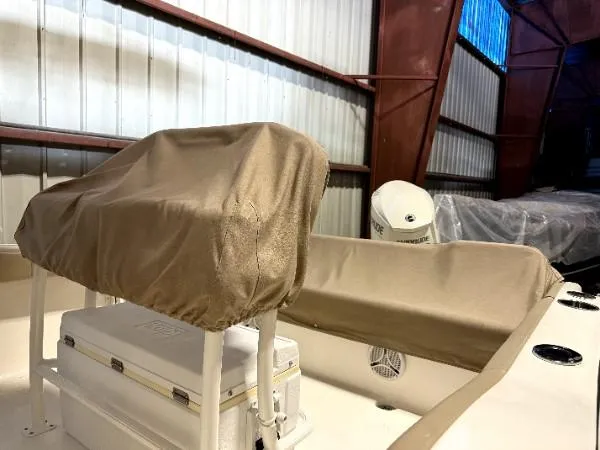 Slide: The Image of 2015 Key West 219 FS boat interior with covered seats in a storage facility. - 5