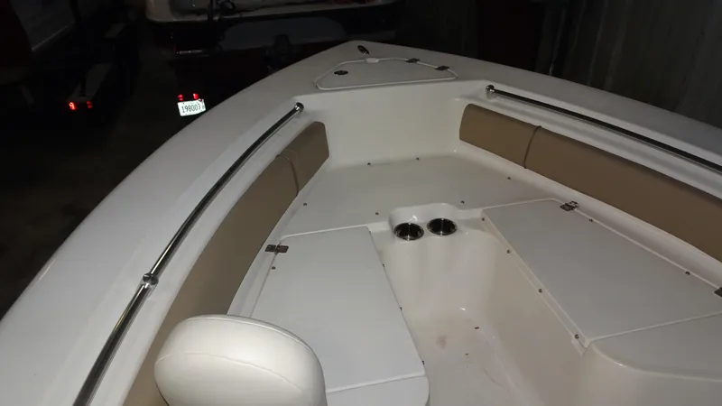 Slide: The Image of 2015 Key West 219 FS boat interior with cushioned seating and cup holders. - 6