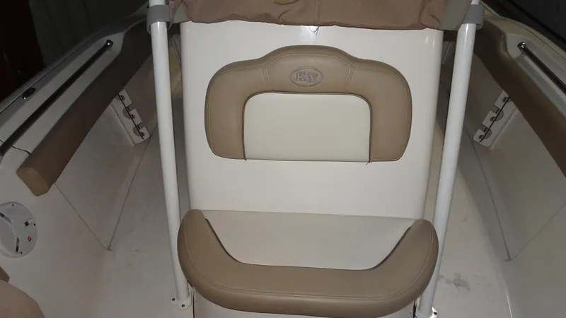 Slide: The Image of 2015 Key West 219 FS boat interior with beige seating and white accents. - 9