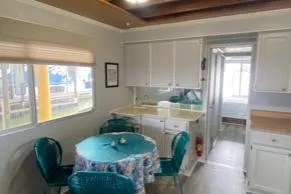 Slide: The Image of Interior of 1985 Sumerset 60 X 14 houseboat with dining area and kitchen. - 11