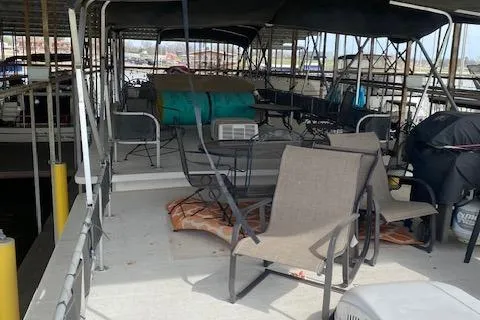 Slide: The Image of 1985 Sumerset 60 X 14 houseboat deck with chairs and covered seating area. - 3
