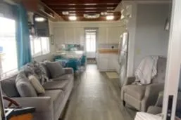 Slide: The Image of 1985 Sumerset 60 X 14 houseboat interior with cozy living area and kitchen. - 4