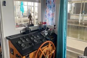 Slide: The Image of 1985 Sumerset 60 X 14 houseboat helm with wooden steering wheel and nautical instruments. - 5