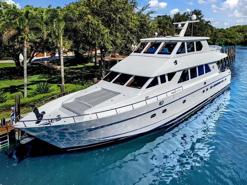 Slide: The Image of Luxurious 2003 Hargrave Sky Lounge yacht docked in a serene, tropical setting. - 0