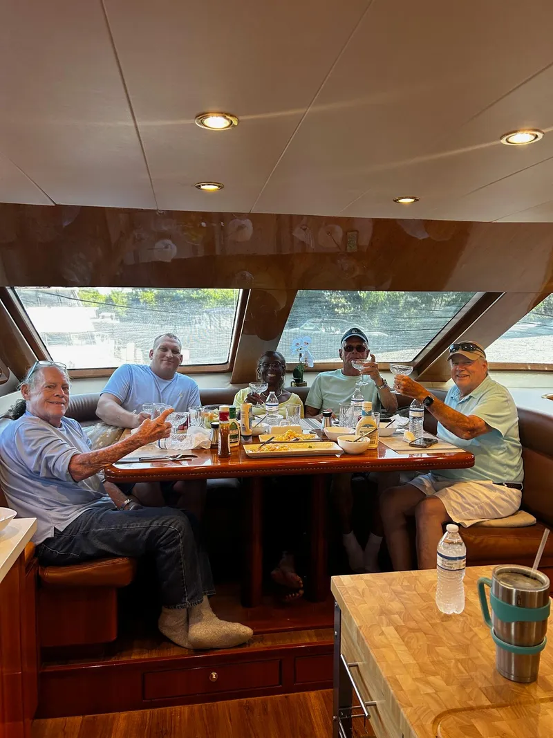 Slide: The Image of Group enjoying a meal inside a 2003 Hargrave Sky Lounge yacht. - 23