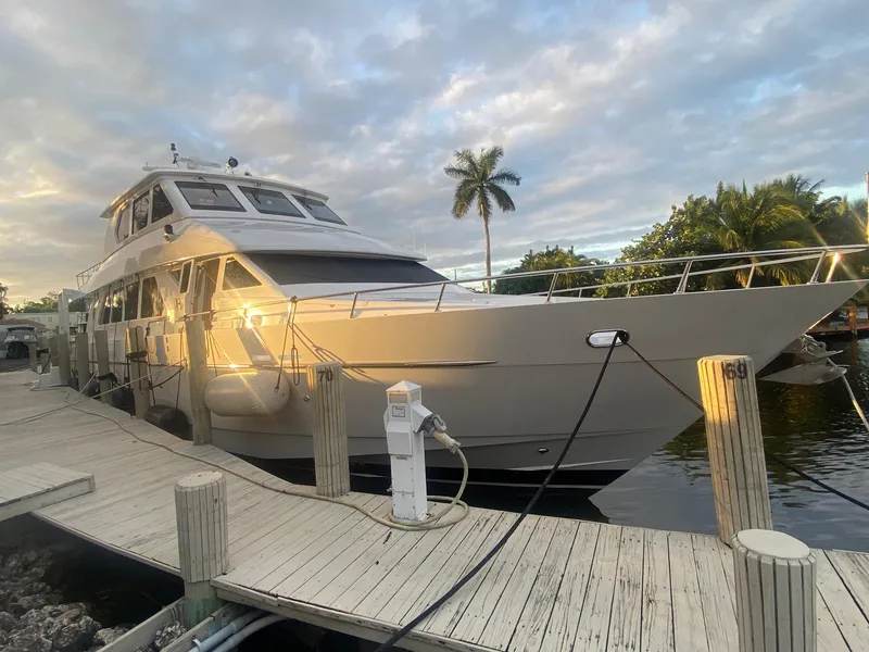 Slide: The Image of 2003 Hargrave Sky Lounge yacht docked at sunset with palm trees in the background. - 3