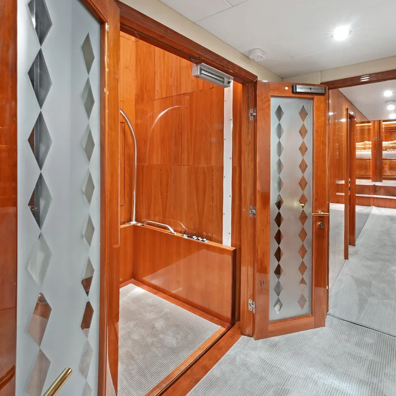Slide: The Image of Luxurious interior of 2003 Hargrave Sky Lounge yacht with wood paneling and frosted glass doors. - 33