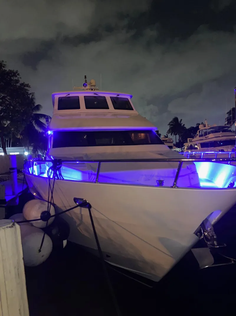 Slide: The Image of 2003 Hargrave Sky Lounge yacht docked at night, illuminated with blue lights. - 48