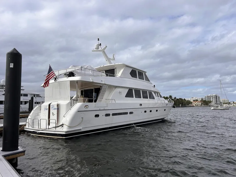 Slide: The Image of 2003 Hargrave Sky Lounge yacht docked, featuring sleek design and American flag. - 49
