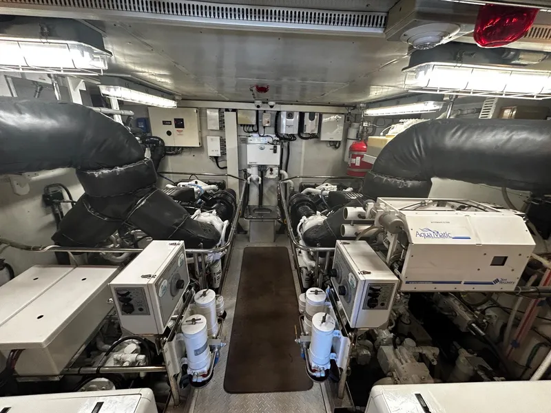 Slide: The Image of Engine room of a 2003 Hargrave Sky Lounge yacht, featuring dual engines and control systems. - 51