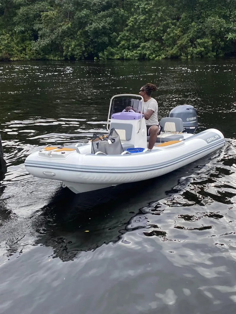 Slide: The Image of Person on inflatable boat navigating river, surrounded by lush greenery. - 59