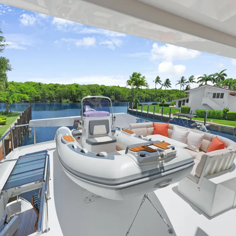 Slide: The Image of Luxurious 2003 Hargrave Sky Lounge yacht deck with inflatable boat and scenic waterfront view. - 8