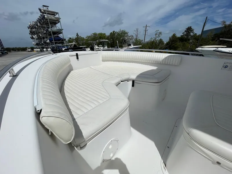 Slide: The Image of 2007 Sea Hunt Triton 207 boat with white cushioned seating and open deck. - 15