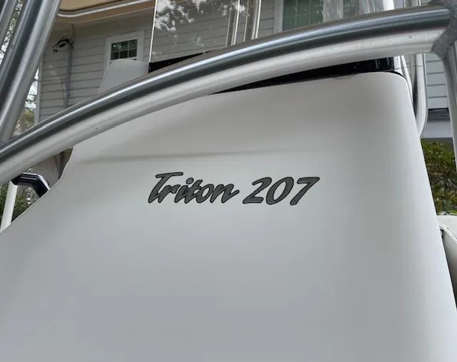 Slide: The Image of 2007 Sea Hunt Triton 207 boat with sleek design and visible branding. - 25