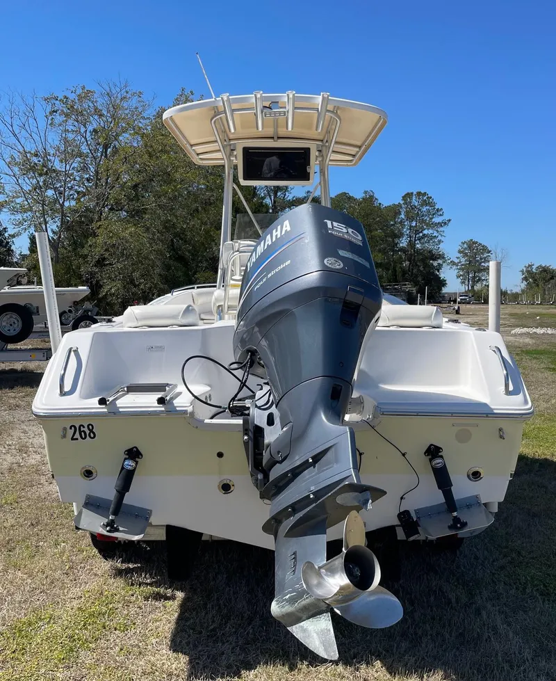 Slide: The Image of 2007 Sea Hunt Triton 207 boat with Yamaha outboard motor, parked on grass. - 8