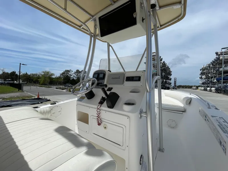 Slide: The Image of 2007 Sea Hunt Triton 207 boat console with steering wheel and navigation equipment. - 9
