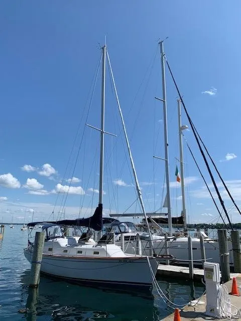 Slide: The Image of 1978 Bombay Clipper Sloop docked under clear blue sky. - 11