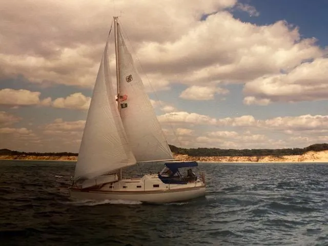 Slide: The Image of 1978 Bombay Clipper Sloop sailing on a sunny day with clouds and distant shoreline. - 14