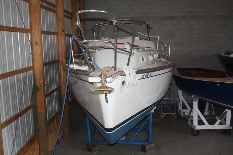 Slide: The Image of 1978 Bombay Clipper Sloop sailboat stored indoors on a stand. - 16