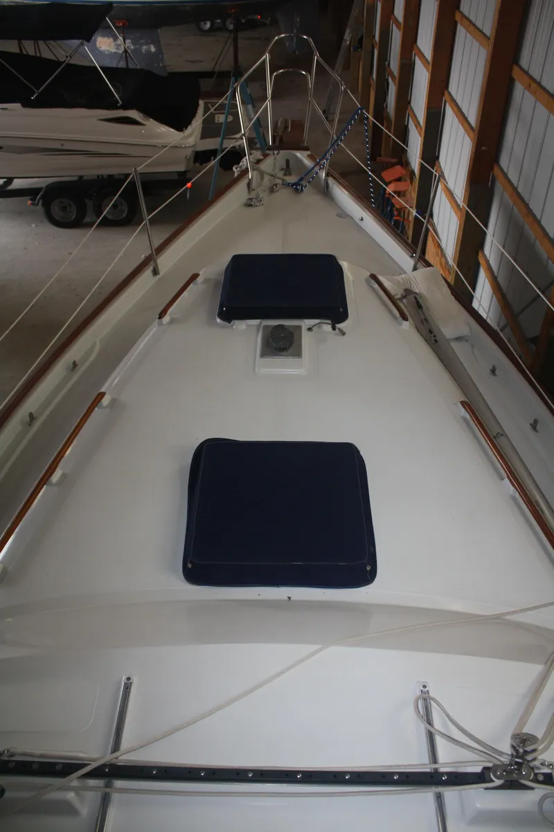 Slide: The Image of 1978 Bombay Clipper Sloop deck view in storage, featuring two hatches and railing. - 30