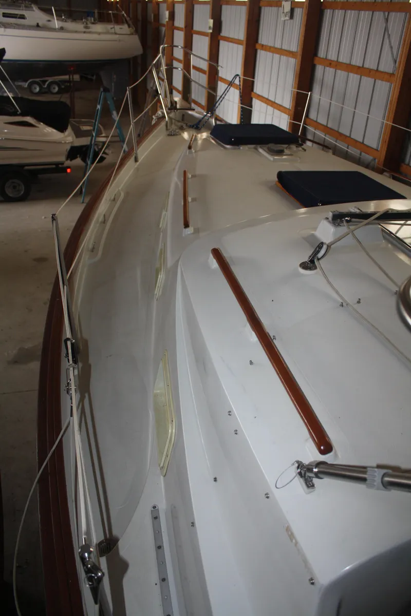 Slide: The Image of 1978 Bombay Clipper Sloop in storage, showcasing deck and rigging details. - 31