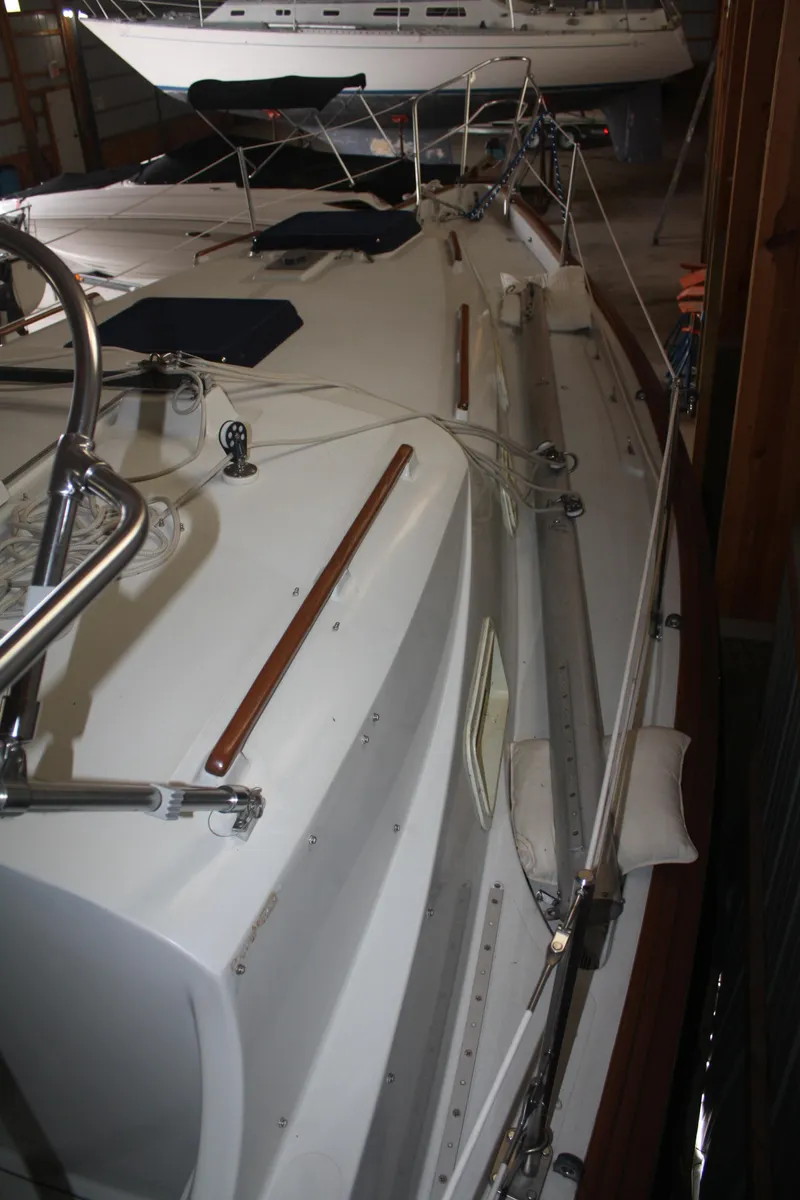 Slide: The Image of 1978 Bombay Clipper Sloop sailboat docked in a marina, showcasing deck and rigging details. - 32