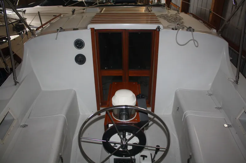 Slide: The Image of 1978 Bombay Clipper Sloop cockpit with steering wheel and wooden hatch. - 34