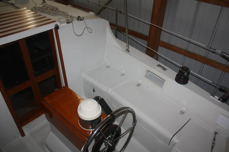 Slide: The Image of 1978 Bombay Clipper Sloop cockpit with steering wheel and wooden accents. - 36