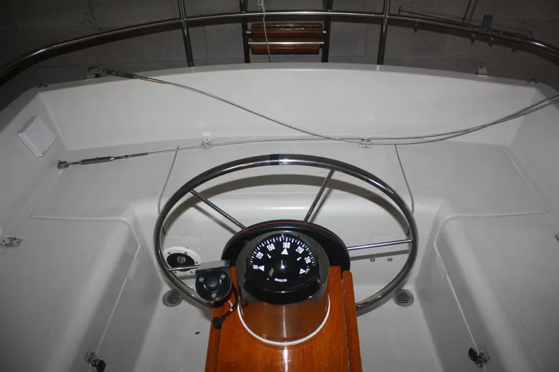 Slide: The Image of Cockpit of a 1978 Bombay Clipper Sloop with steering wheel and compass. - 37