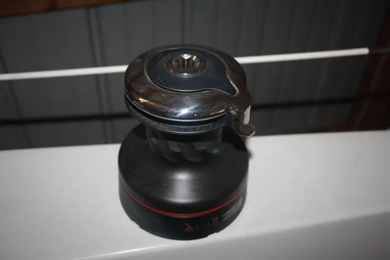 Slide: The Image of 1978 Bombay Clipper Sloop winch, black and silver, mounted on a boat surface. - 38